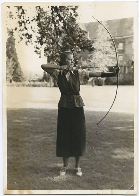 Unidentified young woman poses with a bow and arrow · heritage