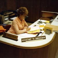 Assistant to Ombudsman at desk